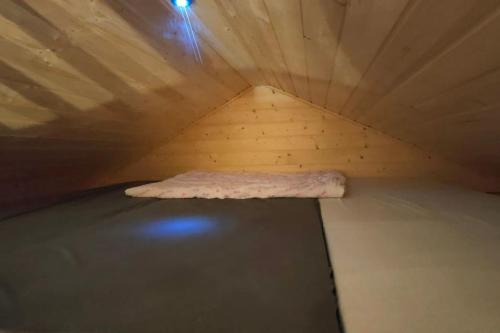 a small room with a bed in the ceiling at Tiny Treperka in Semily