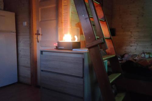 a candle sitting on top of a dresser in a room at Tiny Treperka in Semily