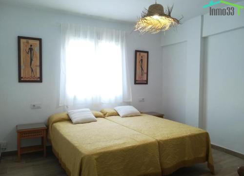 a bedroom with a bed with a large window at LA TERRAZA DE MAR in Villajoyosa