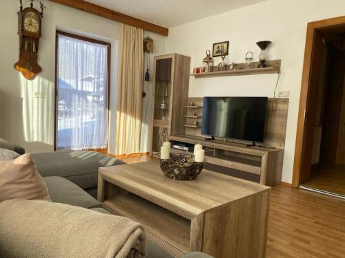 a living room with a couch and a table with a television at Haus Reichlas in Längenfeld