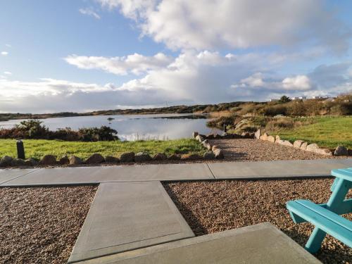 a view of a river from a park with a bench at The Wheelhouse Pod No 6 in Letterkenny