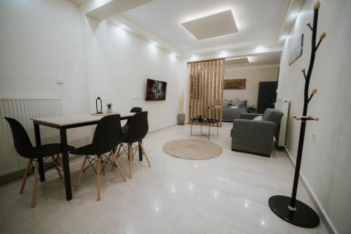 a living room with a dining room table and chairs at Panorama Apartment in Kozani