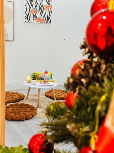 a room with a christmas tree and a table with cookies at NalSol House in Hanoi