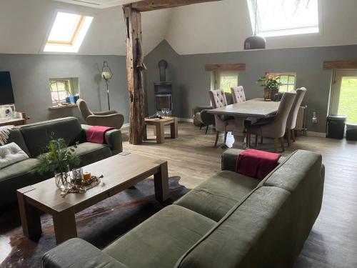 a living room with a couch and a table at Een mooie plek in Markelo