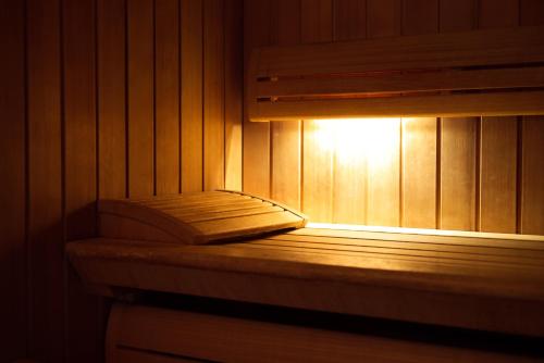 a book sitting on a bench in a sauna at LE CLOS DES SOURCES Hôtel & Spa in Thannenkirch