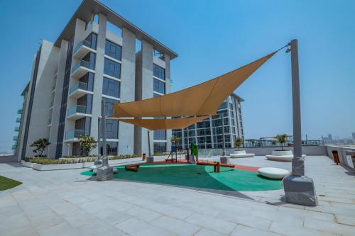 a large apartment building with a large woodenoit at HiGuests - Step Into Heaven In This Lakeside Apartment in Dubai