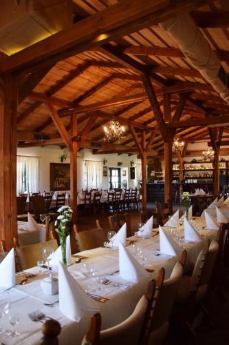 a dining room with white tables and chairs at Bojarski Gościniec in Narewka
