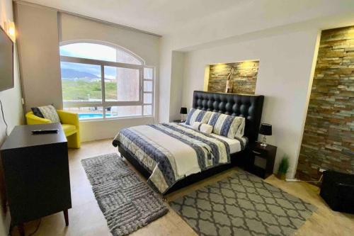 a bedroom with a bed and a large window at Alquiler de Apartamento vacacional en la Isla de Margarita in Pampatar