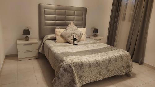 a bedroom with a large bed and two night stands at San Francisco's House in Medina Sidonia