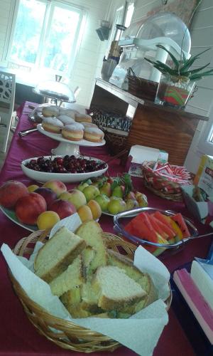 a table topped with lots of different types of bread and fruit at Villa Ghetta Country House in Leverano