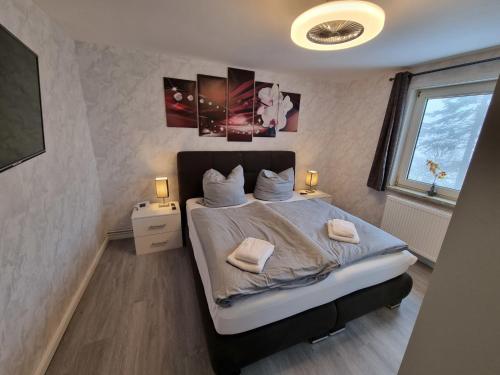 a bedroom with a bed with two towels on it at Haus Ilse Wohnung 8 in Sankt Andreasberg