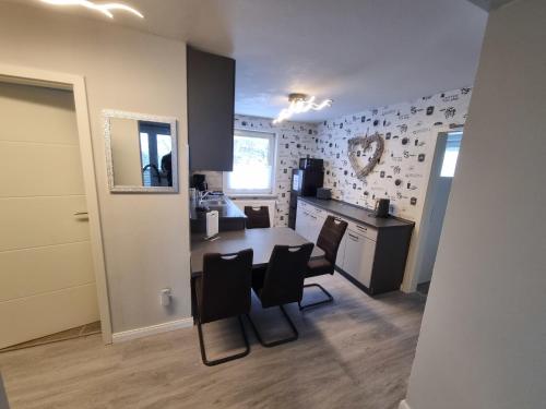 a kitchen and dining room with a table and chairs at Haus Ilse Wohnung 8 in Sankt Andreasberg