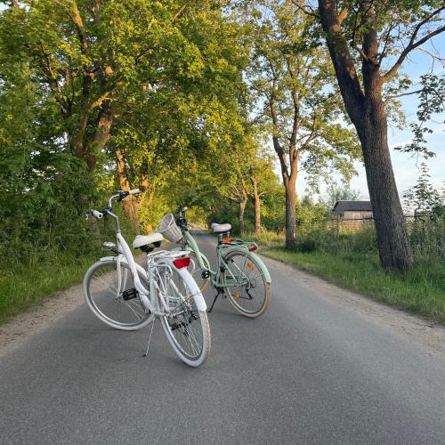 two bikes parked on a road next to each other at Osada Rybacka in Podamirowo