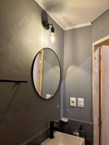 a bathroom with a mirror and a sink at Expreso terminal in Montevideo