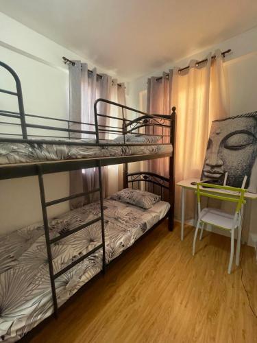 - une chambre avec 2 lits superposés et un bureau dans l'établissement Lily’s Homestay, à Butuan