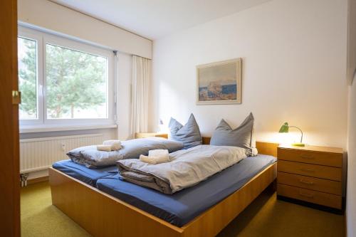 a bedroom with a bed with a blue mattress at Brentschpark Wohnung 72 in Scuol