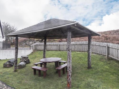 a picnic table and bench in a gazebo at Roselea in Broadford