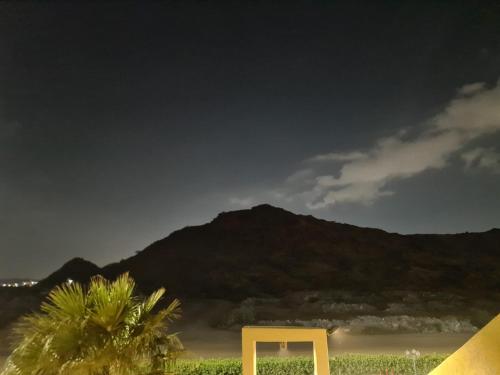 a yellow object in front of a beach with a mountain at شاليهات دشيل لبيوت العطلات الاقتصادية in Taif