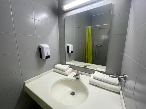 a bathroom with a sink and a mirror at HI Porto - Pousada de Juventude in Porto