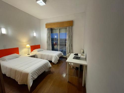 ポルトにあるHI Porto - Pousada de Juventudeのベッド2台とシンク付きのホテルルームです。
