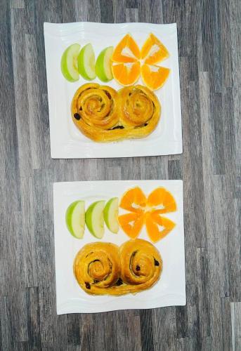 two plates of food with oranges and apples on them at TRMOTEL in Matola