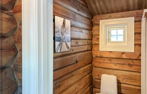 a bathroom with wooden walls and a toilet at Cozy Home In Reinli With Wifi in Reinli