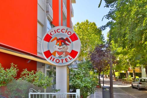 a sign for a hotel on the side of a building at Ciccio Hotel in Misano Adriatico