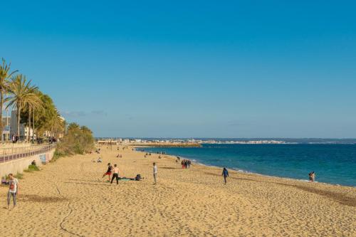a group of people on a beach near the water at Centric in Palma de Mallorca