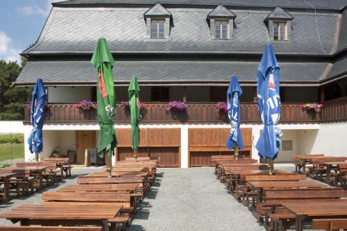 a row of tables and umbrellas in front of a building at Penzion Fojtstvi in Olomouc