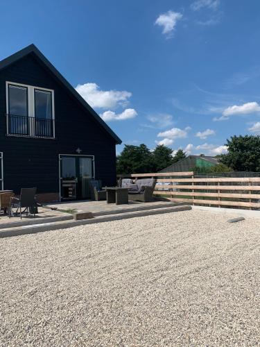 a house with a patio and a fence at Christinahoeve Logies in Boskoop