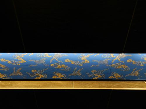 a blue and gold wrapping paper on a shelf at Kyoto Sanjo Ohashi in Kyoto