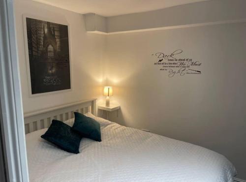 a bedroom with a bed with two pillows on it at Spacious 5 Bedroom House- Harry potter world & London in Watford