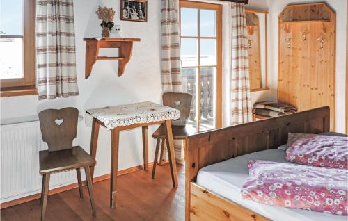 a bedroom with a bed and a table and a chair at 2 Bedroom Gorgeous Home In Schladming in Schladming
