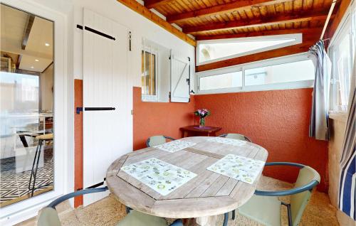 comedor con mesa de madera y sillas en 1 Bedroom Beautiful Home In Dolus-dolron, en Dolus d'Oléron
