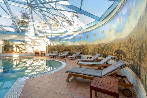 a room with a swimming pool with a mural on the wall at Hotel International in Sinaia