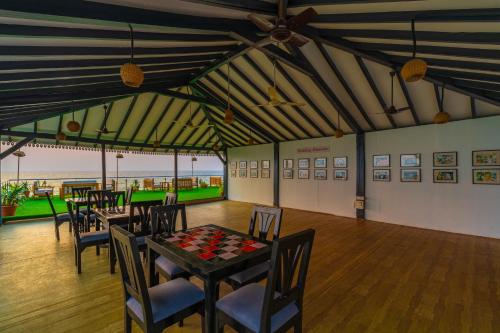 a dining room with tables and chairs in a building at La Cabana Beach & Spa, By Ashvem Beach in Mandrem