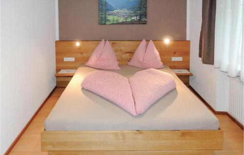a bed with pink pillows in the shape of a heart at Stunning Apartment In Pfunds With 3 Bedrooms And Wifi in Pfunds