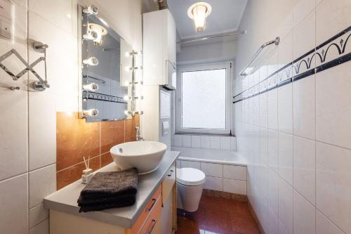 a white bathroom with a sink and a toilet at Devon in Münster