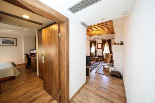 a hallway with a door leading to a living room at Hotel Çarshia e Jupave in Gjakove