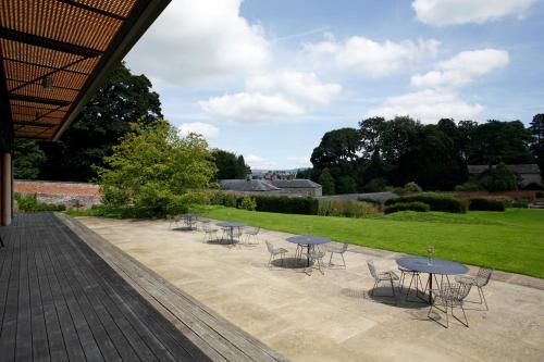 a group of tables and chairs on a patio at 2 Sulphur Wells at Broughton Sanctuary in Broughton