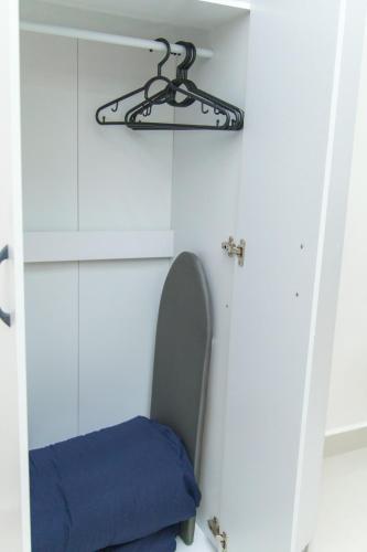 a room with a chair with a blue cushion at FxA Studios Core Soho Suites KLIA 1 & 2 Sepang FREE WIFI in Sepang