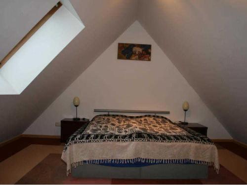 a bedroom with a bed in a attic at Ferienwohnung "Im Alten Gut" in Schaderode