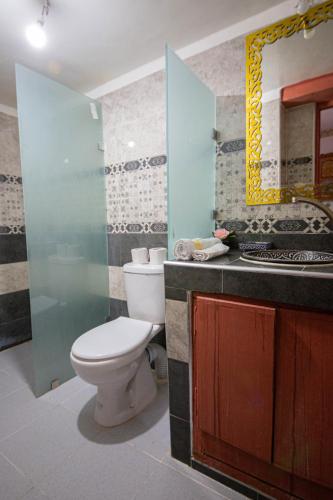 a bathroom with a toilet and a sink and a mirror at Riad Fes Hayat - Confort Stay in Fès