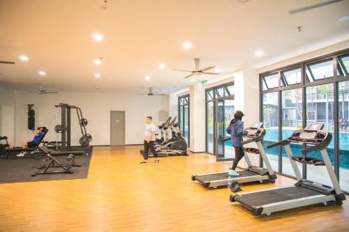 a group of people exercising in a gym with treadmills at FxA Studios Core Soho Suites KLIA 1 & 2 Sepang FREE WIFI in Sepang