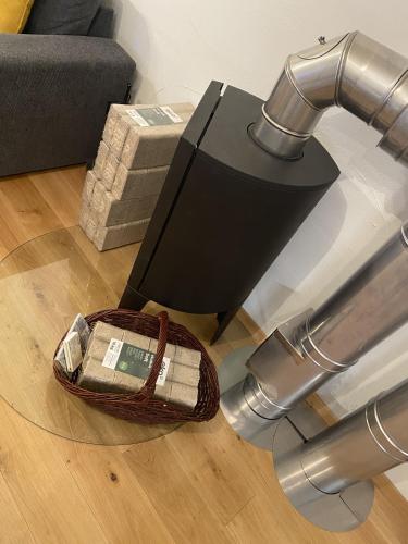 a table with a lamp and a basket on the floor at Apartmány Vodohospodár in Mýto pod Ďumbierom