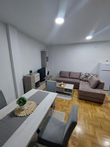 a living room with a couch and a table and chairs at Cista DESETKA 2 in Požarevac