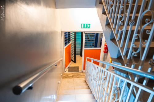 a hallway with a staircase in a building with a door at Sweet Mama in Bijilo