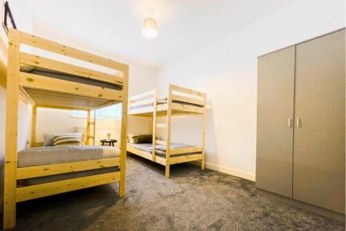 a bedroom with two bunk beds and a closet at Tudor Tootsies in Liverpool