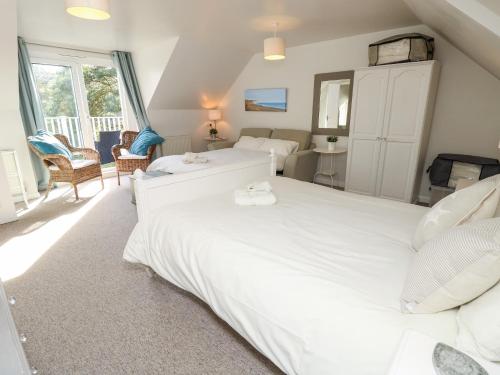 a bedroom with two large white beds in a room at Burwyns in Ventnor