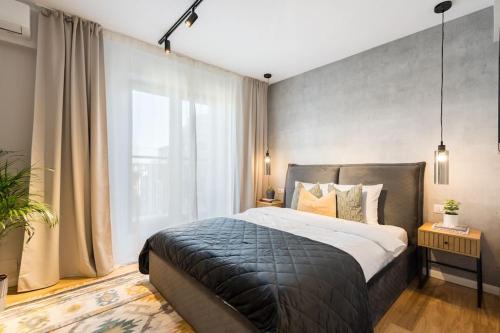 a bedroom with a large bed and a large window at Stunning Views Luxury Studio in Bucharest